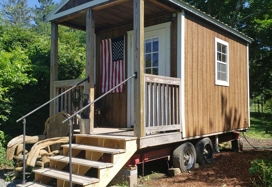 Single-wide manufactured home set on its lot with entry steps